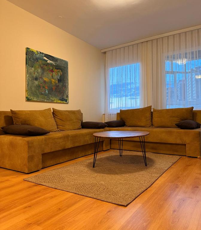 a living room with a couch and a table at Apartment in Prishtina, Kosovo in Pristina