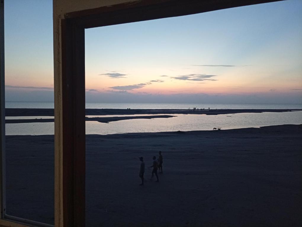 two people walking on the beach at sunset at Cartagena Hostel in Cartagena de Indias
