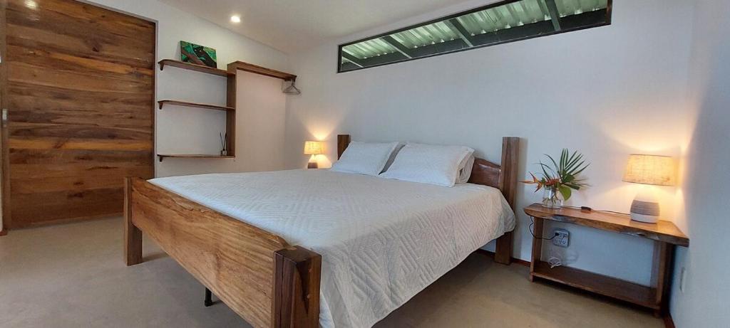 a bedroom with a large bed and a window at Casa Vista Pavones in Pavones