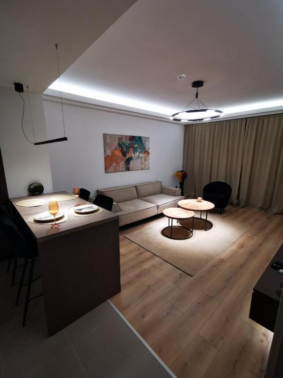 a living room with a couch and a table at Cevahir Sky View in Skopje