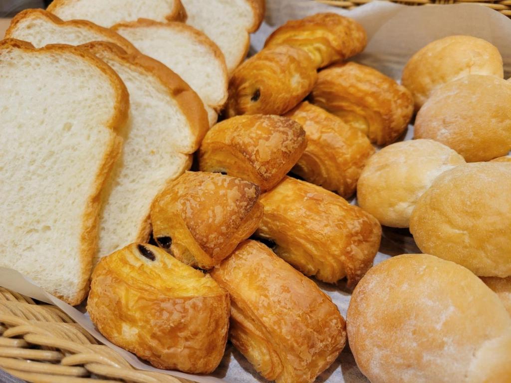 a bunch of bread and pastries in a basket at Smile Hotel Osaka Tennoji - Vacation STAY 41030v in Osaka