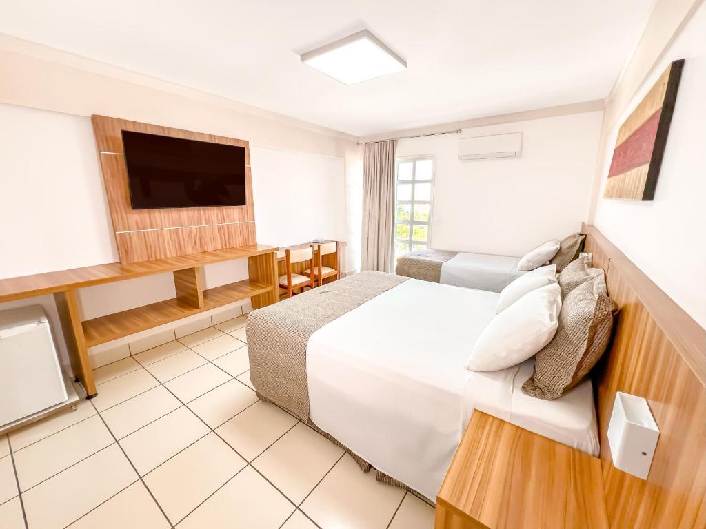 Ένα ή περισσότερα κρεβάτια σε δωμάτιο στο diRoma Exclusive direto com o Grupo diRoma com acesso ao Acqua Park e Café da manhã