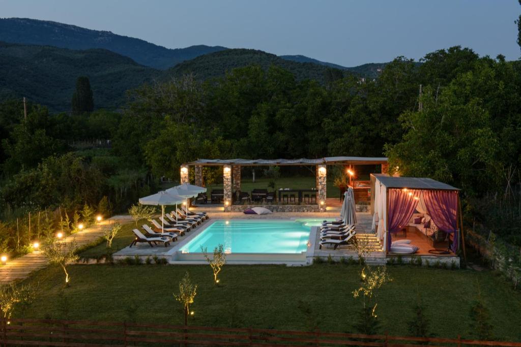 a backyard with a swimming pool and a gazebo at Levantes Villas in Kala Nera