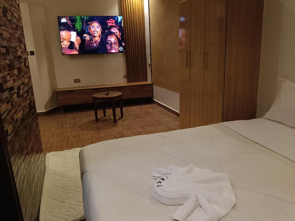 a hotel room with a bed with a pile of white towels at Kunste bnb in Nakuru