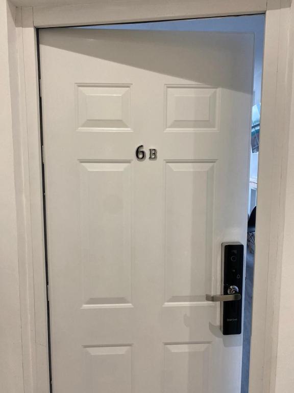 a white door with the letter g on it at Stylish modern 2 bedroom flat 6B in Denton