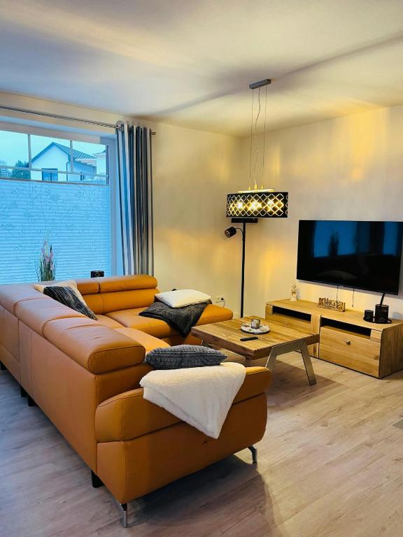 a living room with a couch and a flat screen tv at Klütz Semi-Detached House, 2 Double Beds, 2 Single Beds in Klütz