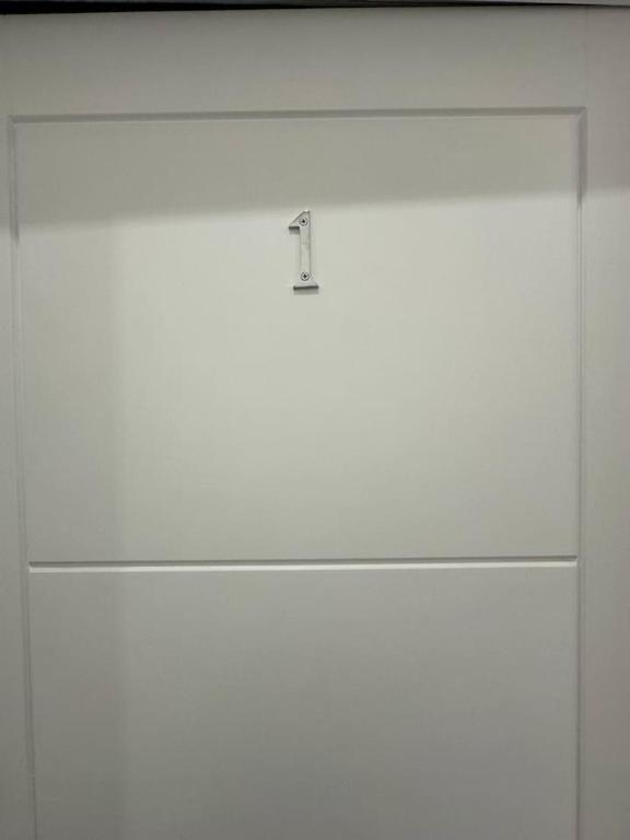 a white door with a knob on top of it at Clapham Junction moments away in London
