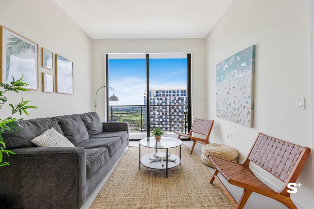 a living room with a couch and a table at DTW Doral 2BD Condo Skyline Views in Miami