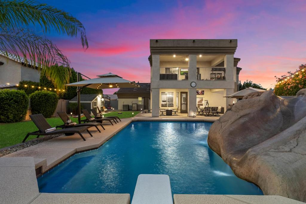 a home with a swimming pool and a house at Northstar Zen Resort- Rock Waterslide - Pool - Spa - Secret Tunnel - Epic Game Room in Glendale