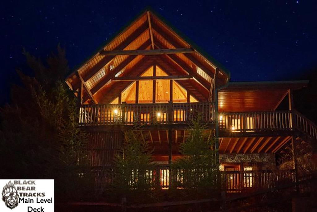a large wooden house at night with lights at Black Bear Tracks in Gatlinburg