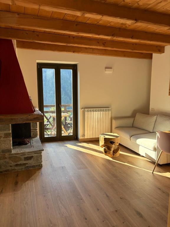 a living room with a couch and a fireplace at Casa Sofia Panoramic View and Private Box in Temù