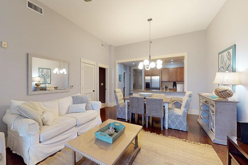 a living room with a white couch and a table at Redfish Village M1-220 in Blue Mountain Beach