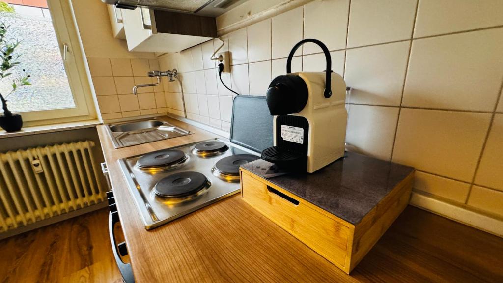 a small kitchen with a stove top in a room at 3-room apartment with parking space Sleepomat in Aschaffenburg