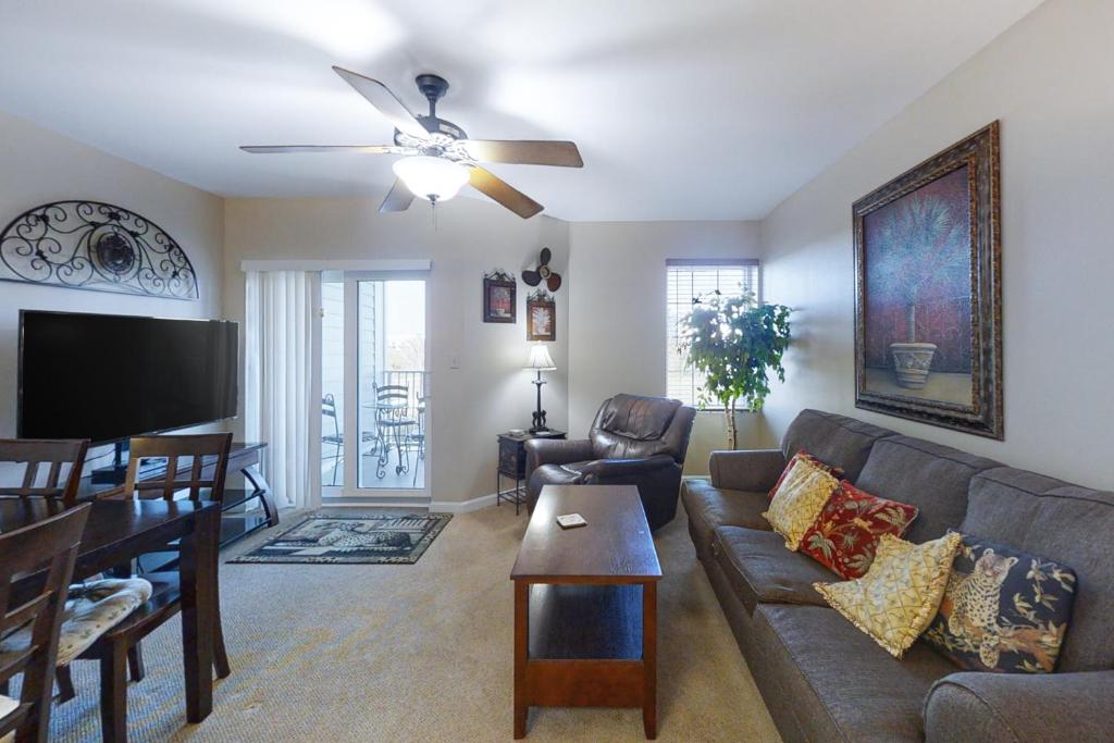 a living room with a couch and a ceiling fan at Grand Caribbean 121 in Orange Beach