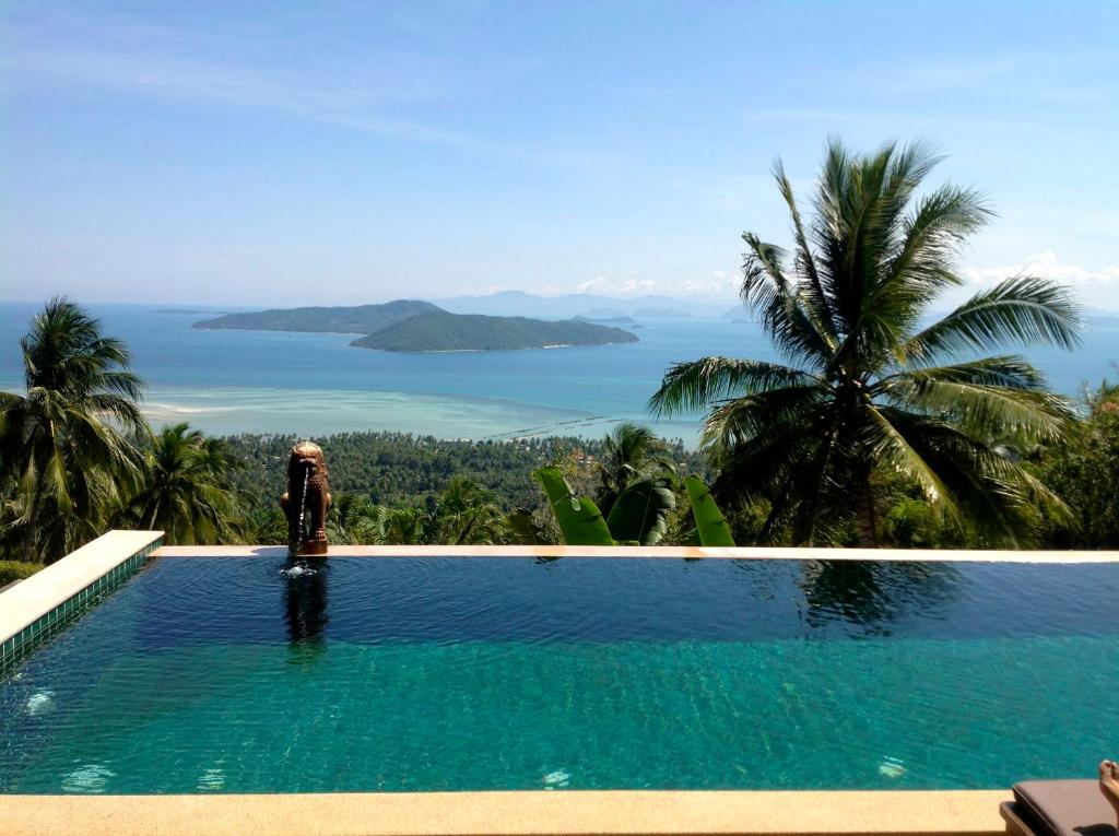 a swimming pool with a view of the ocean at Villa Taling Ngam Amazing Sea view in Taling Ngam Beach