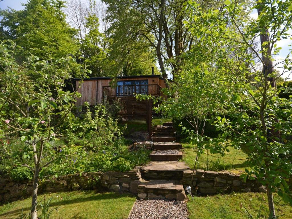 a garden with a stone path leading to a house at 1 bed property in Gilwern Brecon Beacons 75206 in Gilwern