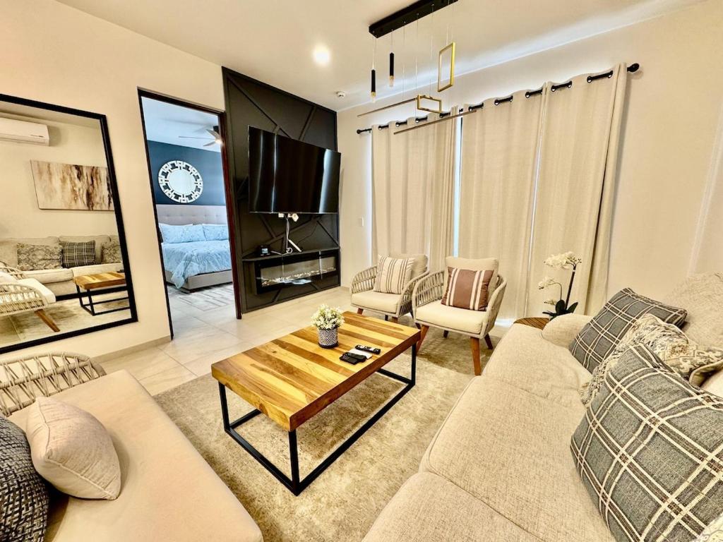 a living room with a couch and a table at Your escape in Cabo Comfortable and elegant apartment in Cabo San Lucas