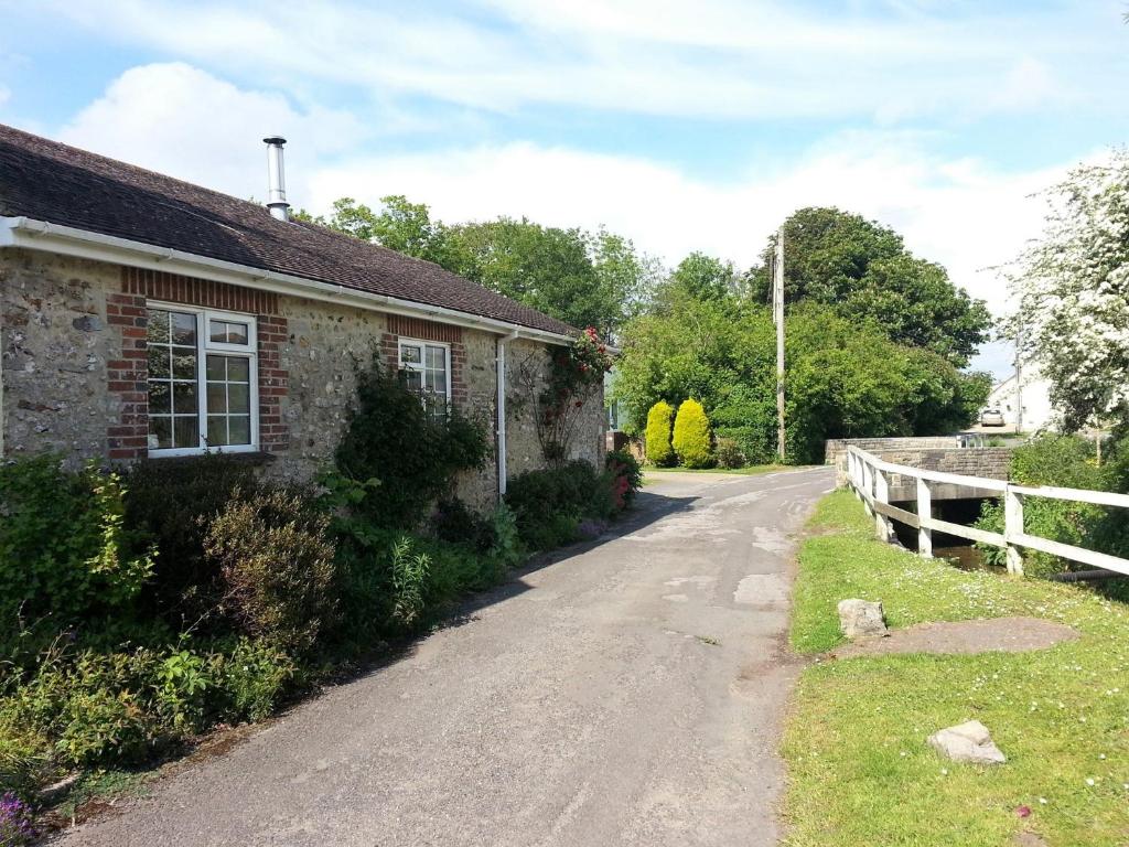 an empty road next to a brick house at 1 Bed in Winfrith Newburgh 75156 in Winfrith Newburgh