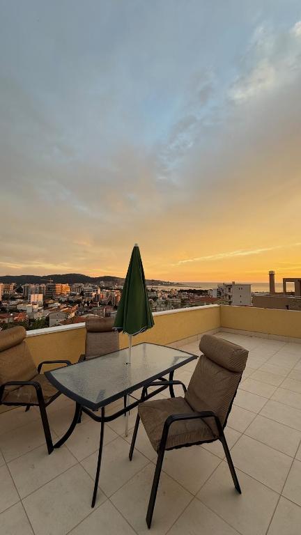 a patio with a table and chairs on a roof at Villa Nadia in Bar