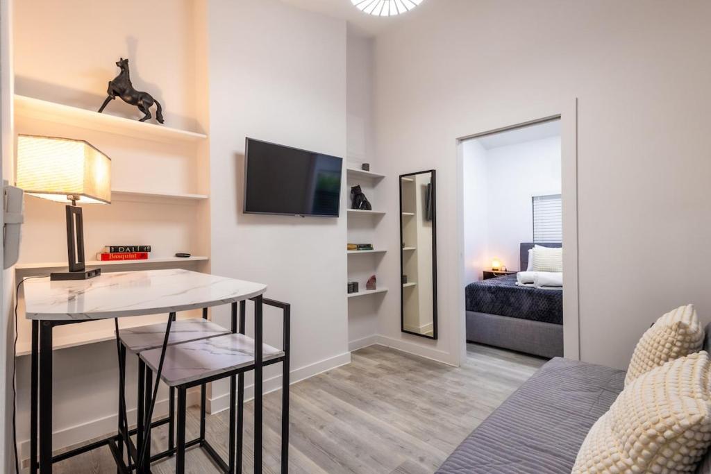 a living room with a table and a bedroom at The Side Villa in Miami