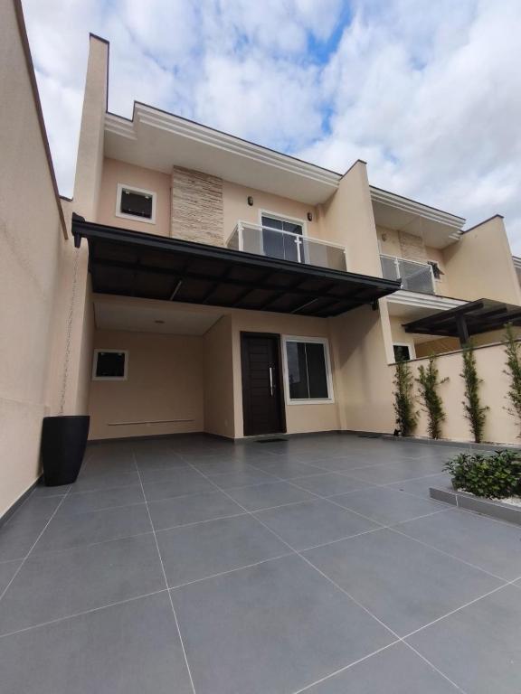 une maison avec une grande allée devant elle dans l'établissement Casa de temporada, à Joinville