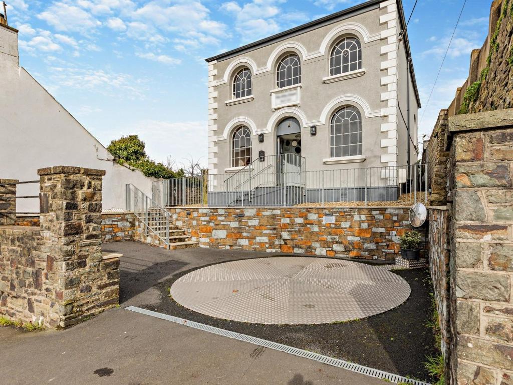 a large white building with a gate in front of it at 3 Bed in Barnstaple 87116 in Fremington