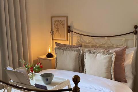 a bedroom with a bed with a laptop on it at Birch House Ballina in Ballina