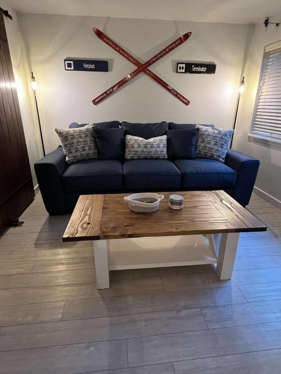 a living room with a blue couch and a coffee table at Powder and Paddle in McCall