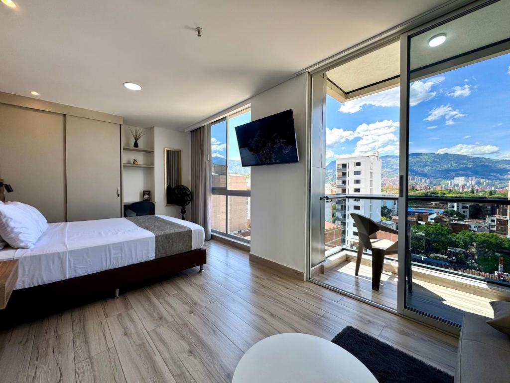 a bedroom with a bed and a view of a city at Torre Zurich Luxury in Medellín