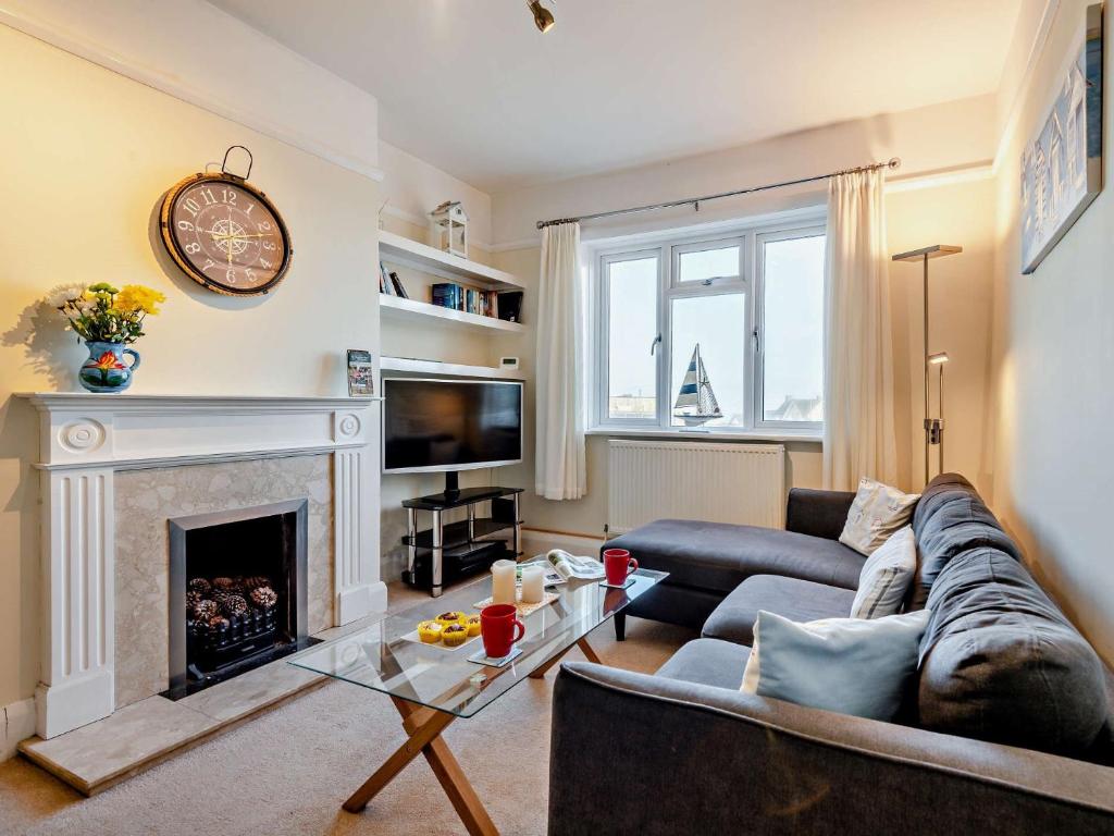 a living room with a couch and a fireplace at 1 Bed in Barton On Sea 91664 in Barton on Sea
