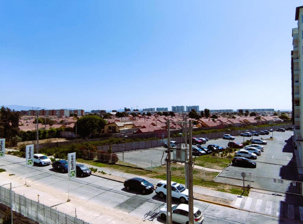 a parking lot with cars parked in a parking lot at Acogedor departamento sector Puertas del Mar in La Serena