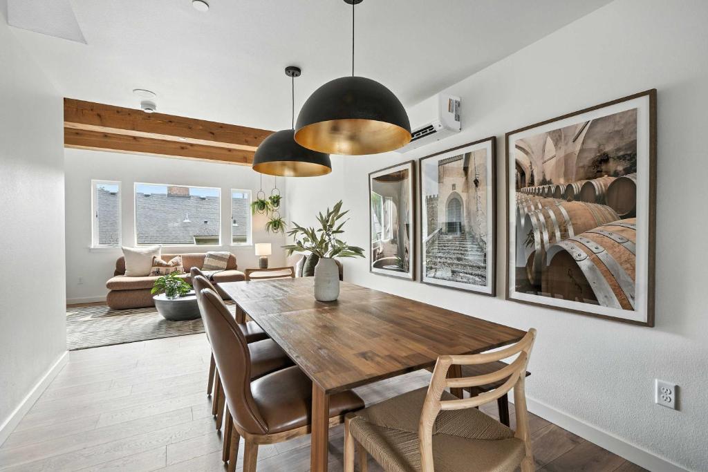 a dining room with a wooden table and chairs at The Adelynn- New Lux Build in Center of PDX in Portland