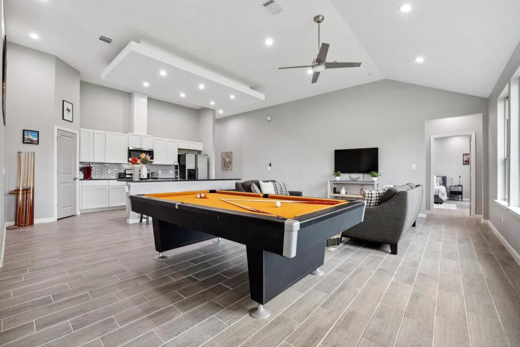 a living room with a pool table in it at Modern Escape in Cedar Creek in Cedar Creek