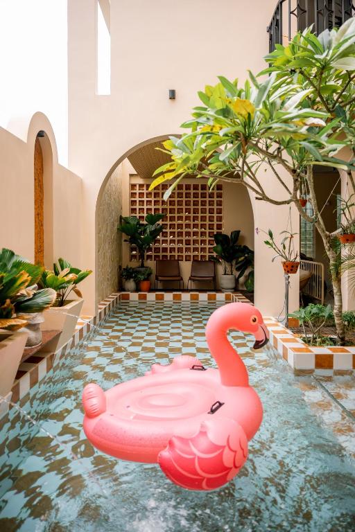 a pink swan in the middle of a swimming pool at Palmera Hoi An Villa & Apartment in Hoi An