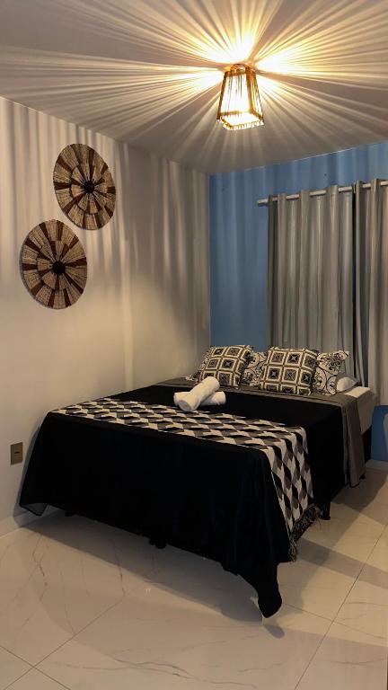 a bedroom with a large bed with pillows on it at House in Itacaré in Itacaré