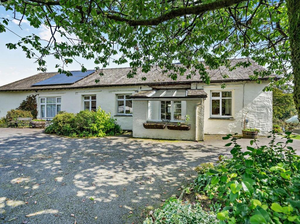 a large white house with a large driveway at 2 Bed in Outgate and Tarn Hows LLH01 in Hawkshead