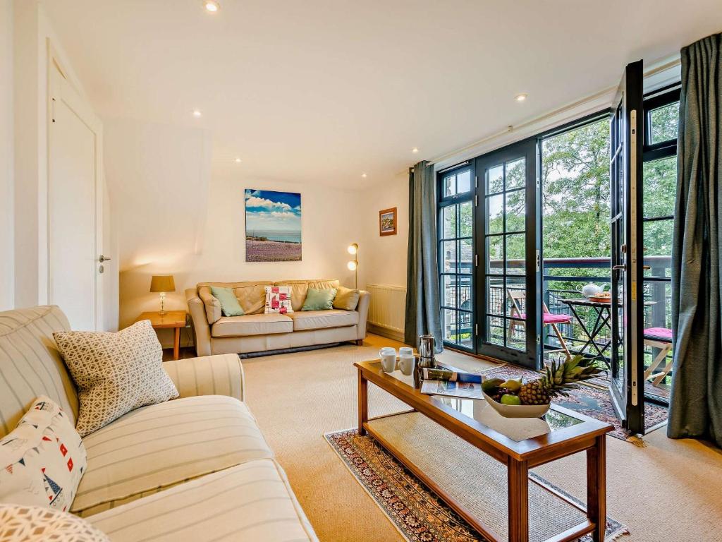 a living room with a couch and a table at 3 Bed in Lostwithiel 93041 in Lostwithiel