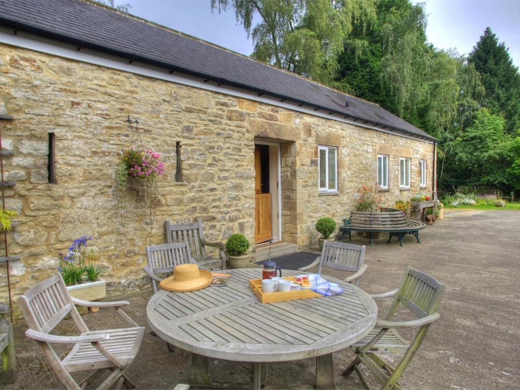 a table and chairs in front of a stone building at 2 Bed in Rowlands Gill CN192 in Stanley
