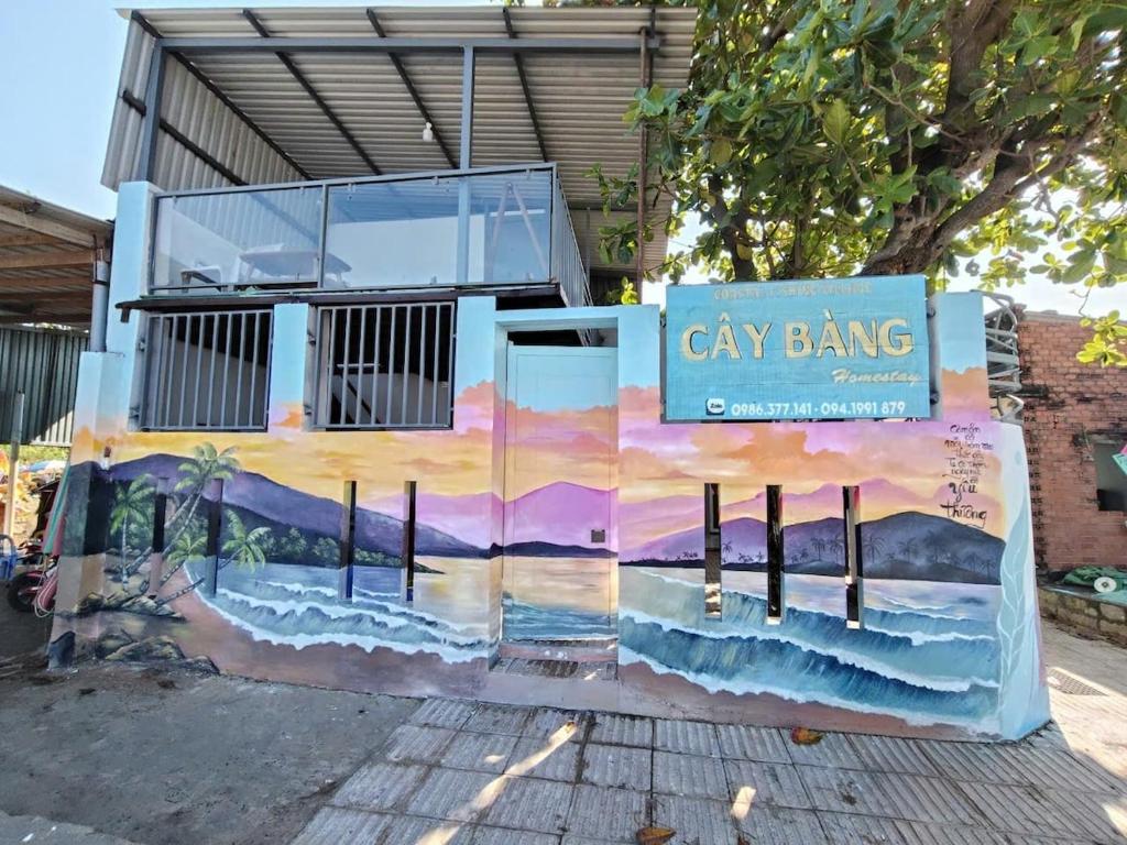 a building with a painting of the ocean at Cay Bang Homestay in Long Hai