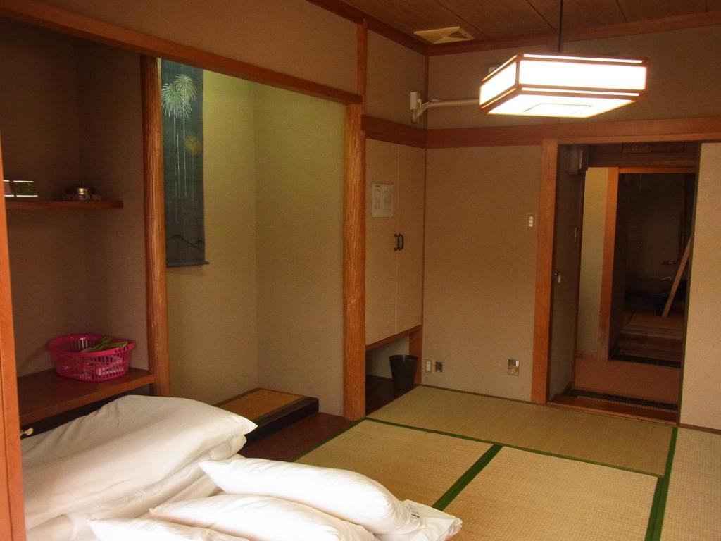 Postel nebo postele na pokoji v ubytování Guesthouse Shirahama