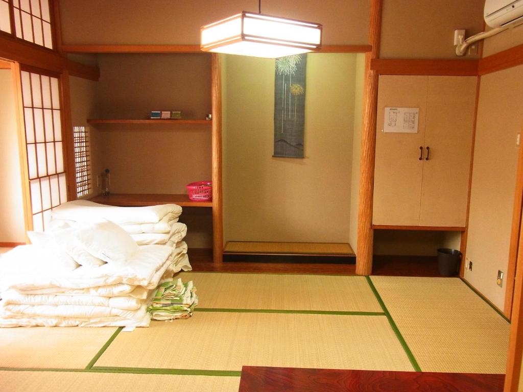 Postel nebo postele na pokoji v ubytování Guesthouse Shirahama