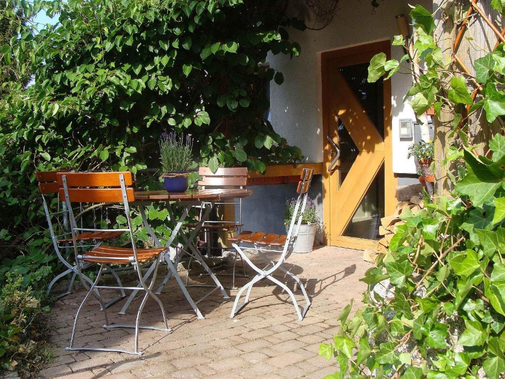 a patio with two chairs and a table with plants at Blackforest Ferienwohnung in Sankt Georgen im Schwarzwald