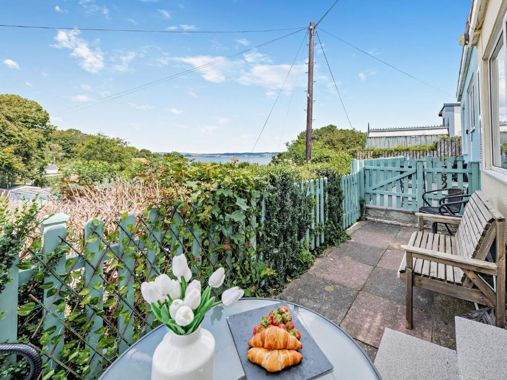 a table with a vase of flowers on a balcony at 2 Bed in Brixham BX079 in Brixham
