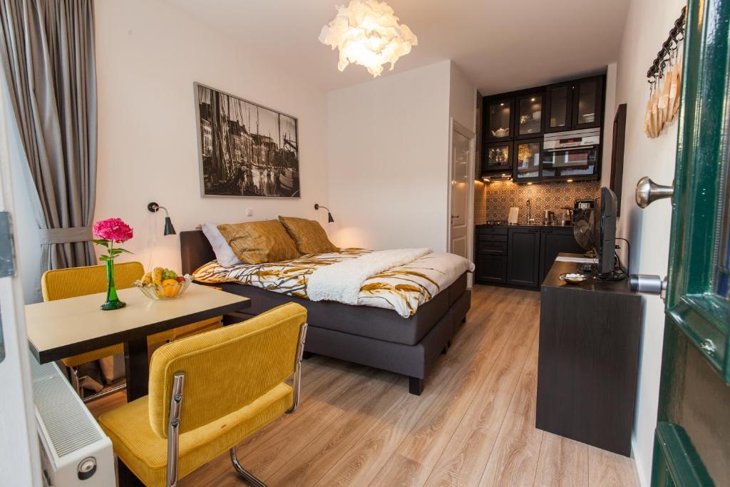 a bedroom with a bed and a table and a desk at Lutje Kerklaan in Groningen