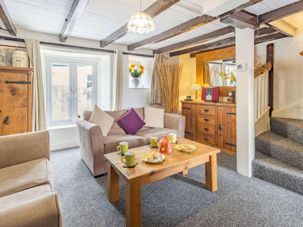 a living room with a couch and a table at 2 Bed in Brixham 88019 in Brixham