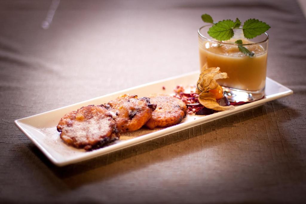 a plate of food with a drink on a table at Amselgrundschlösschen in Kurort Rathen