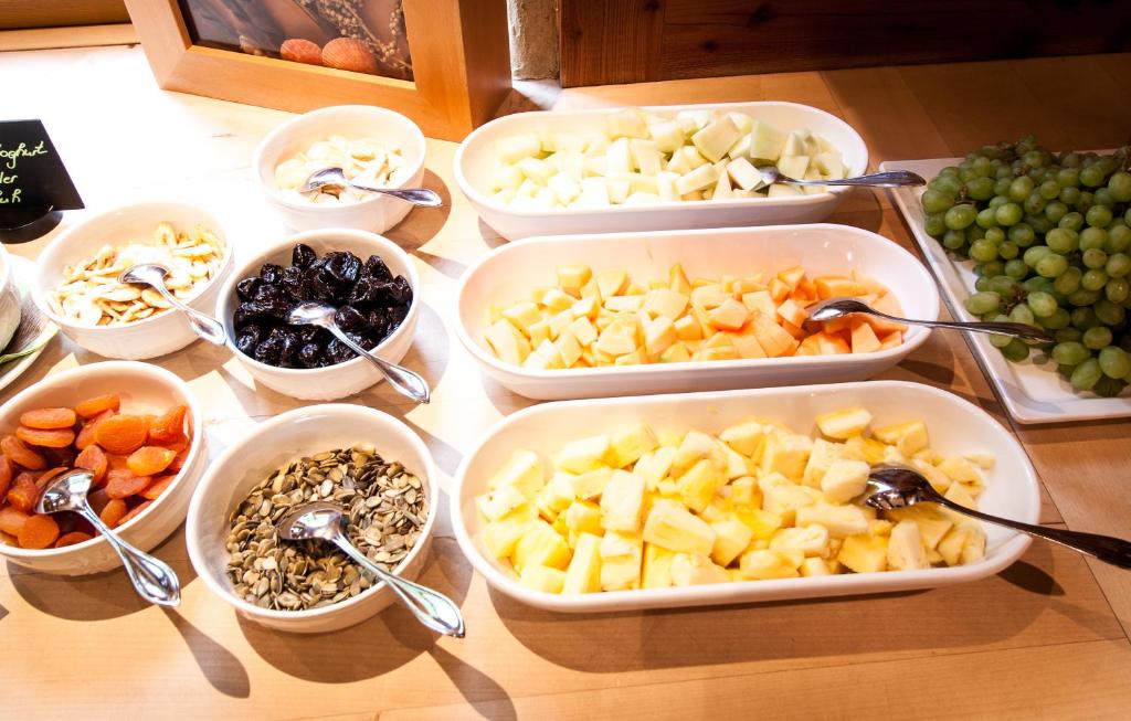 a table with four trays of different fruits and vegetables at Amselgrundschlösschen in Kurort Rathen