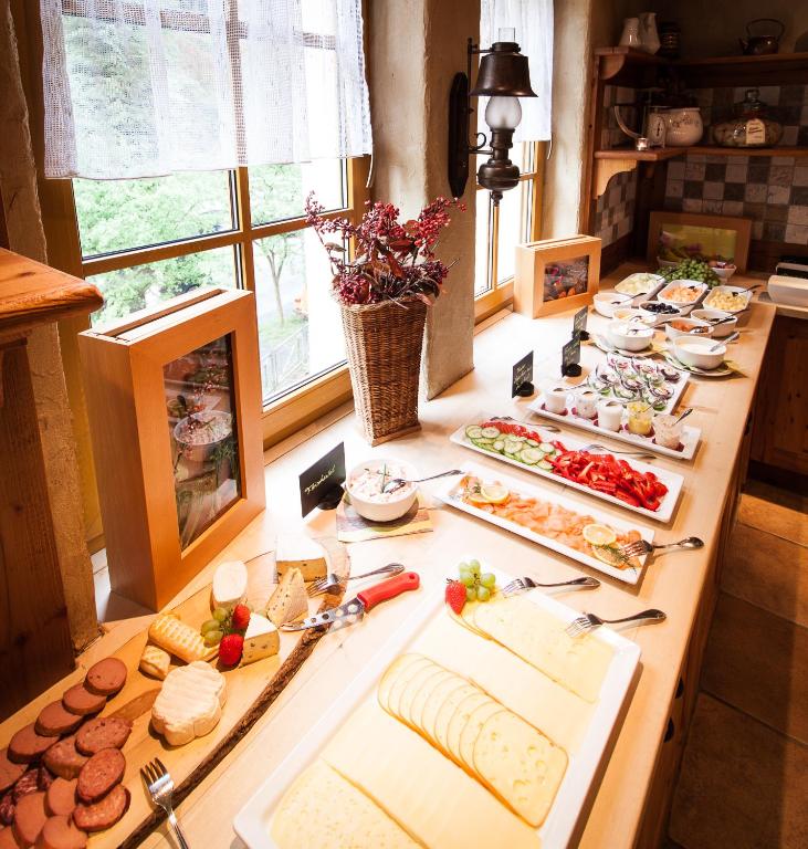 a table with many different types of food on it at Amselgrundschlösschen in Kurort Rathen