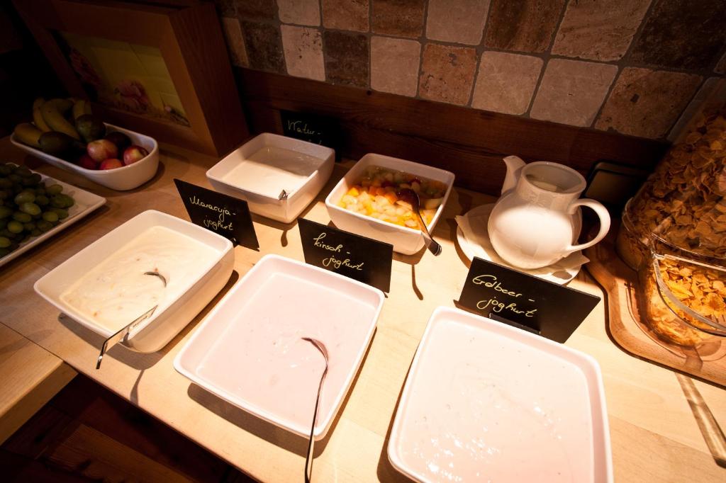 a table with trays of food on top of it at Amselgrundschlösschen in Kurort Rathen