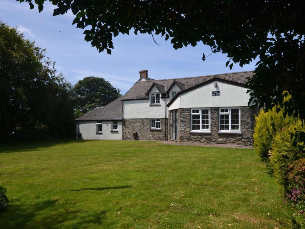 a house with a grassy yard in front of it at 2 Bed in Woolacombe 77248 in West Down
